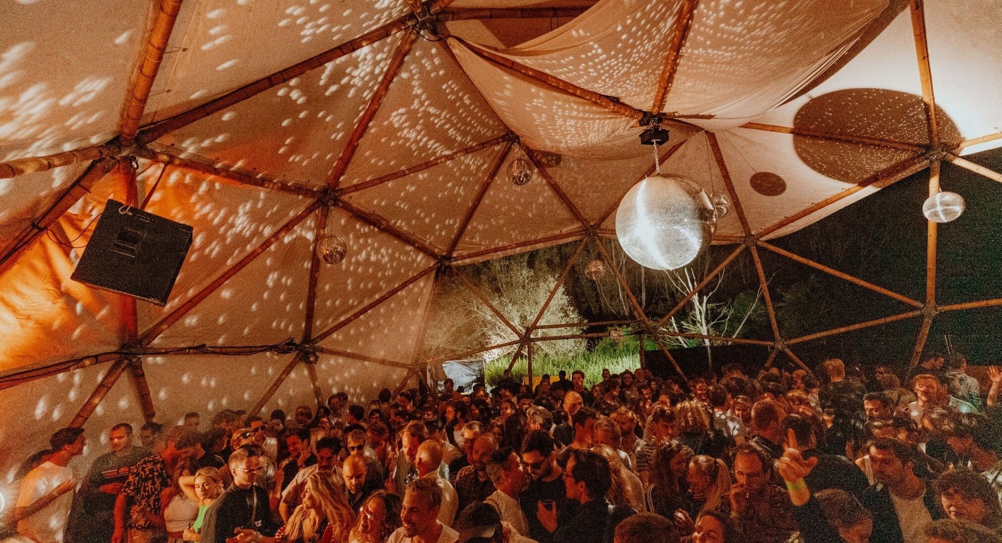 Curfew geodesic dome with disco ball and crowd
